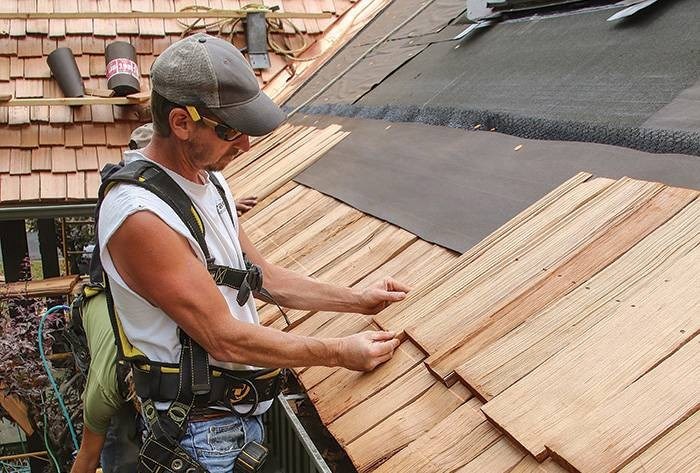 Roofer replacing a cedar roof in Maryland