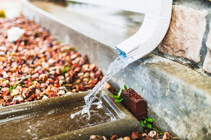 checking gutters and drainage during roof inspection in Springfield, VA